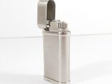 silver metal lighter on a white surface with a white background