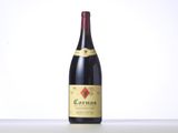 a bottle of red wine sitting on top of a table