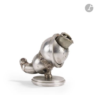 a silver statue of a dog with a hat on it ' s head