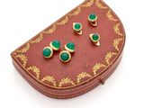 an image of a pair of green earrings sitting on top of a red box