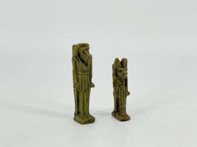two ancient bronze figurines of a man and a woman