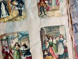 a person holding an old book with pictures of people on it