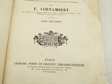 a book opened on a table with a picture of a coat of arms on top of it
