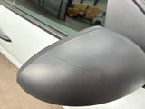 a side view mirror of a car with a car in the background
