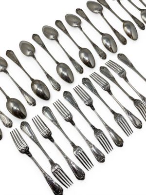 a lot of silver spoons and forks on a white surface