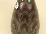 a brown vase with a green design on it