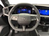 the interior of a car with a steering wheel and dashboard controls
