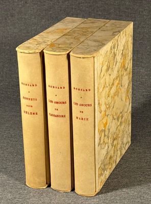 three books are stacked on top of each other on a table