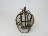 a small metal bird cage with a bird on top of it