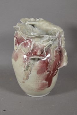 a white vase with a red and white design on it