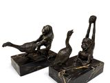 pair of bronze figurines of a man and a woman on a marble base