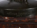a statue of a man riding a horse on top of a table