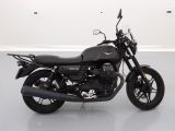 a black motorcycle that is parked in a white room