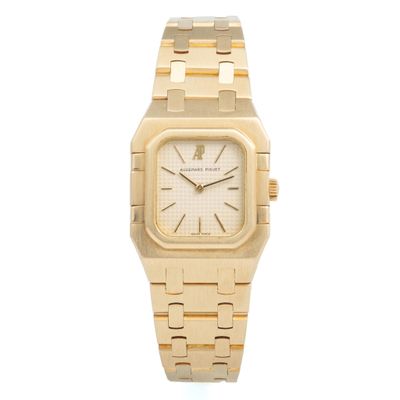 an image of a gold wrist watch with a white dial
