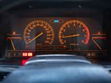 a close up of a car dashboard with a speedometer and gauges