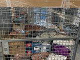 a cage with a bunch of birds inside of it