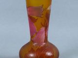 a glass vase with flowers on it on a table