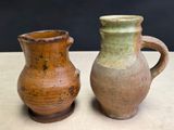 two brown and green vases sitting on a table