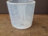 a glass cup that is sitting on a wooden table