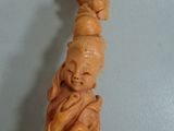 statue of a woman with a dragon on her head on a shelf