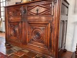 a large wooden cabinet in the middle of a living room