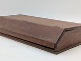 an old wooden box with a lid on a white background