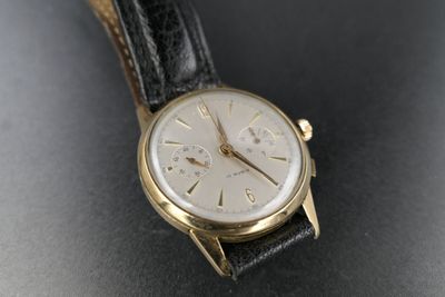 an image of a wrist watch on a black surface