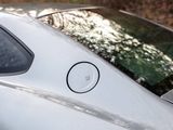a close up of a car ' s rear window with a sticker on it