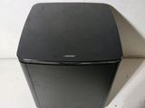 a small black box sitting on a white surface