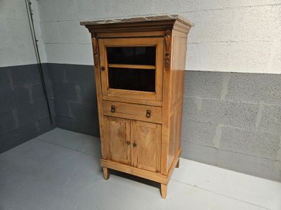 a small wooden cabinet with a glass door on top of it