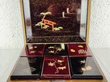 a small wooden box with four compartments on a table