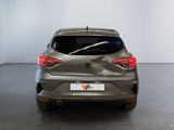 the rear end of a grey car in a white room