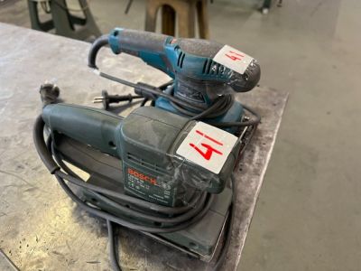 une ponceuse électrique posée sur une table dans une pièce