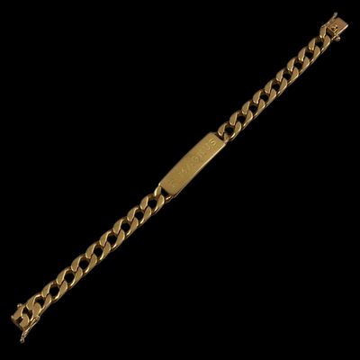 a close up of a gold bracelet on a black background