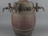 a large metal pot with a handle on a gray background