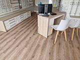 two chairs and a table in a room with glasses on the wall