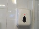 a paper towel dispenser on the wall in a public bathroom