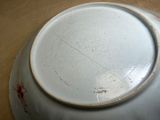 a white plate with a red design on it