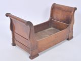 a wooden sleigh that is sitting on a white surface