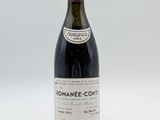 a bottle of wine sitting on top of a white table