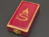 a small red box with a gold dragon on it