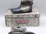 pair of black and silver boots sitting on top of a box