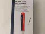 packaging of a red and black pen sitting on top of a white table