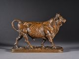 a bronze statue of a bull on a wooden base