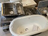 a white sink sitting on top of a pile of boxes