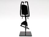 statue of a woman in a black dress on a black base