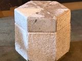 a small box sitting on the floor in front of a fire place
