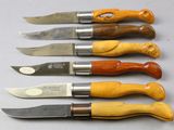 several different types of knives are lined up on a table