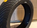 a close up of a person holding a tire on a cardboard box