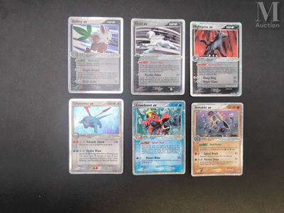several pokemon cards are lined up on a black surface